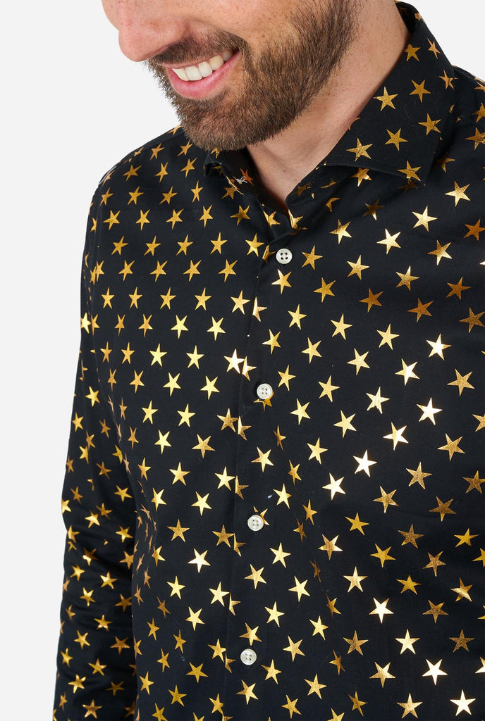 Man wearing black men's shirt with golden foil stars, close up