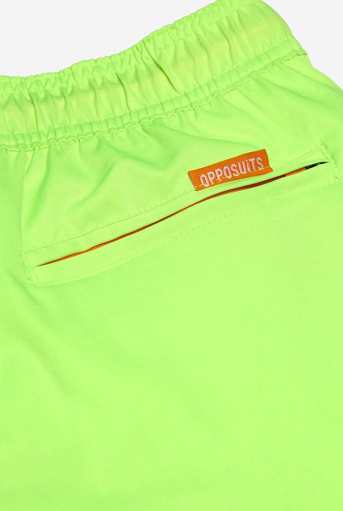 Man wearing Neon lime green swim trunks for men, close up