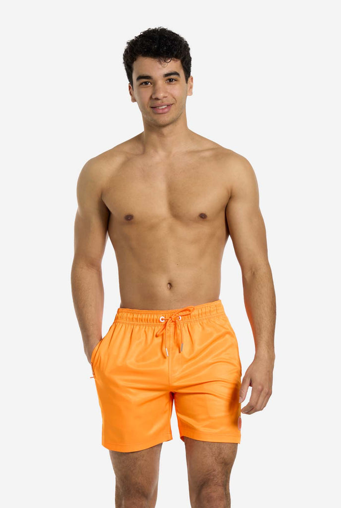 Man wearing Neon Vivid Orange swim trunks for men