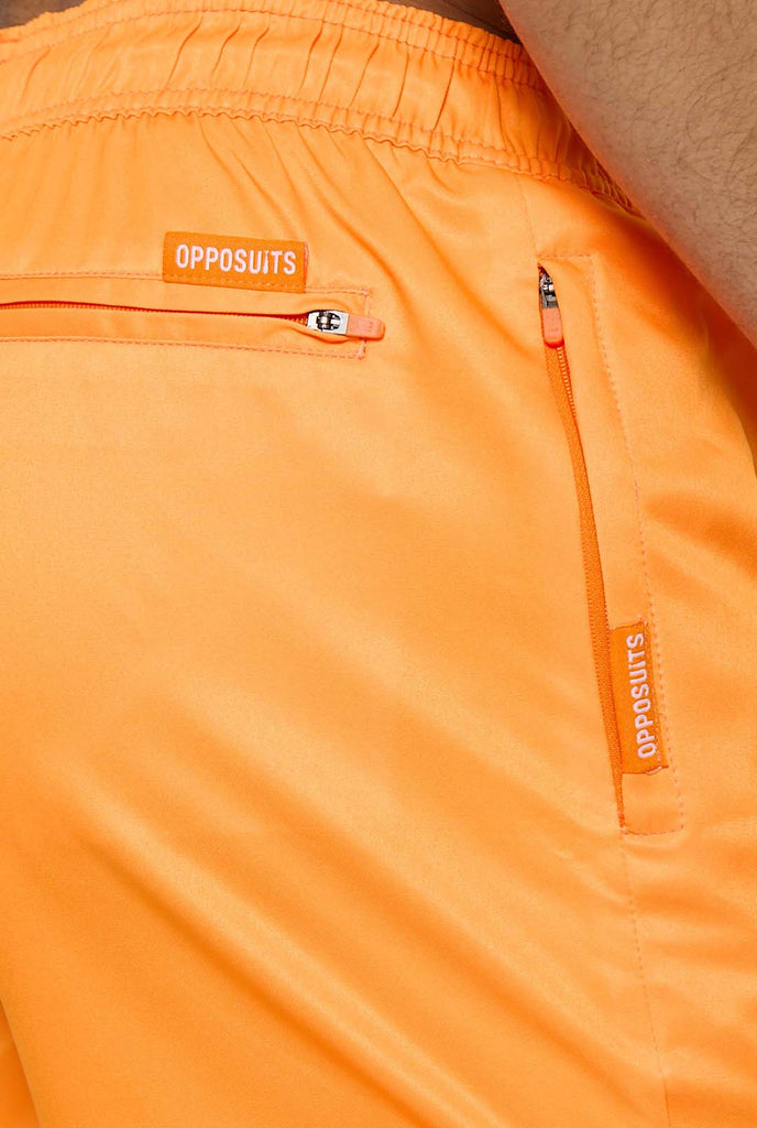 Man wearing Neon Vivid Orange swim trunks for men, close up