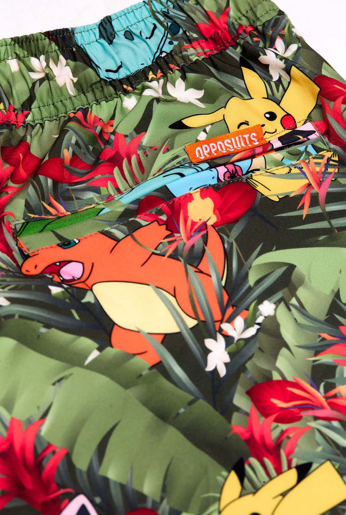 Man wearing swim trunks with Pokemon forest print, close up