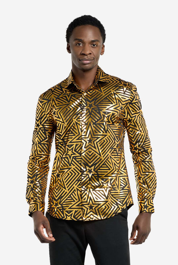 This image features a men’s shirt from OppoSuits with a vibrant gold and black geometric star print pattern. The shirt has a reflective finish that highlights the intricate star and line designs, creating a dynamic and stylish look. Perfect for those who want to stand out, this shirt is both bold and fashionable, ideal for parties, holiday celebrations, or nightlife. The model wears it paired with black pants.