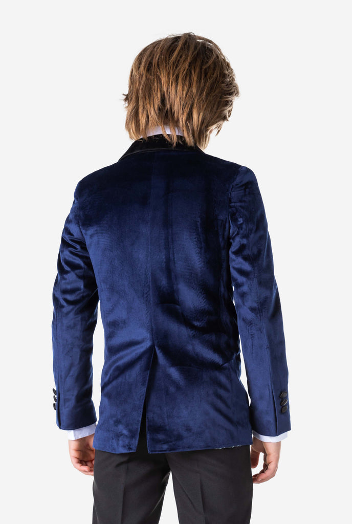 Boy wearing blue velvet Christmas dinner jacket, view from the back