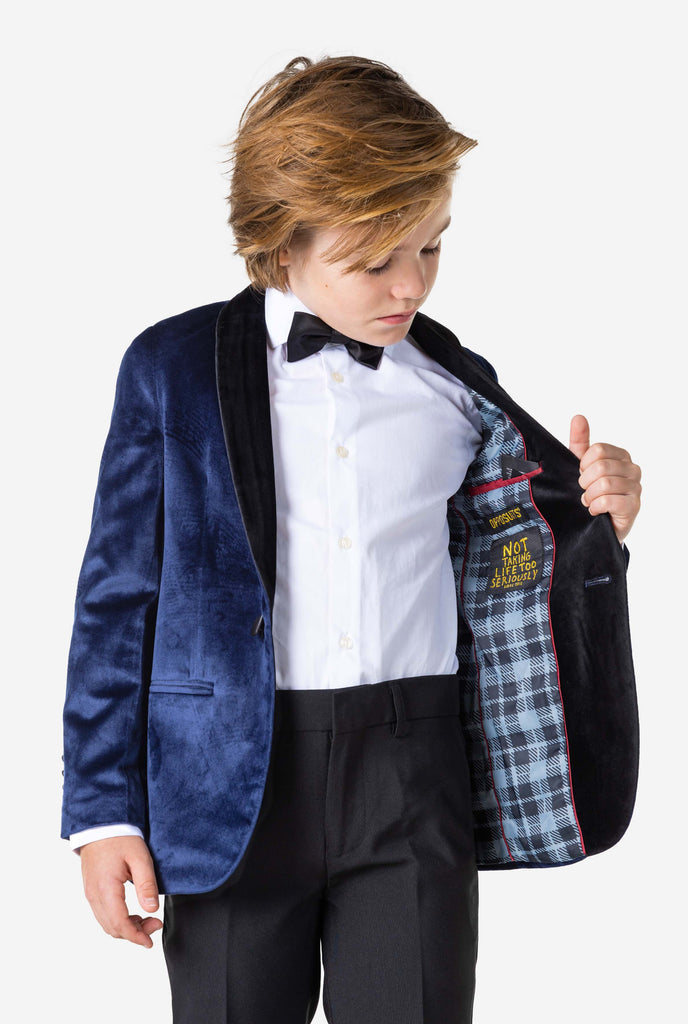 Boy wearing blue velvet Christmas dinner jacket