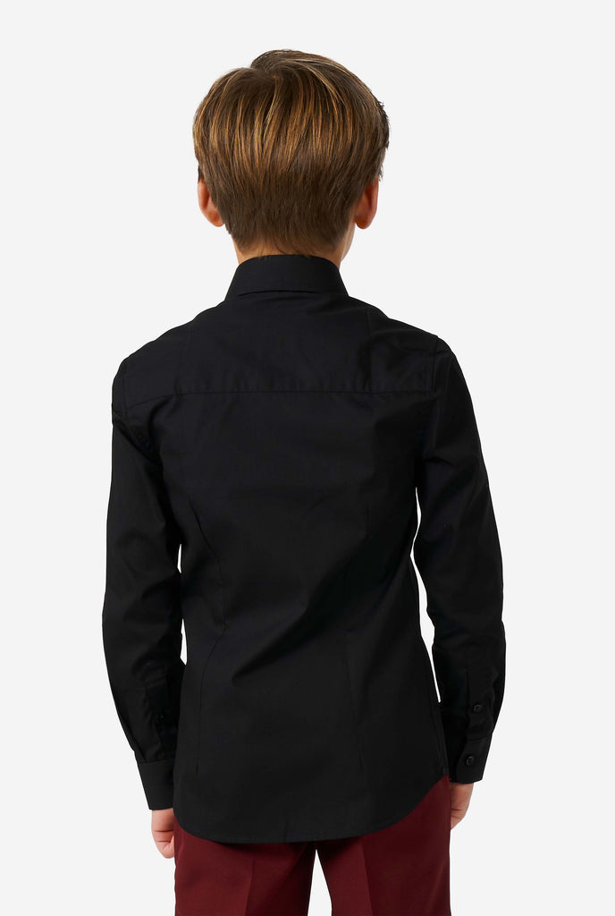 Boy wearing black long sleeve shirt for boys, view from the back