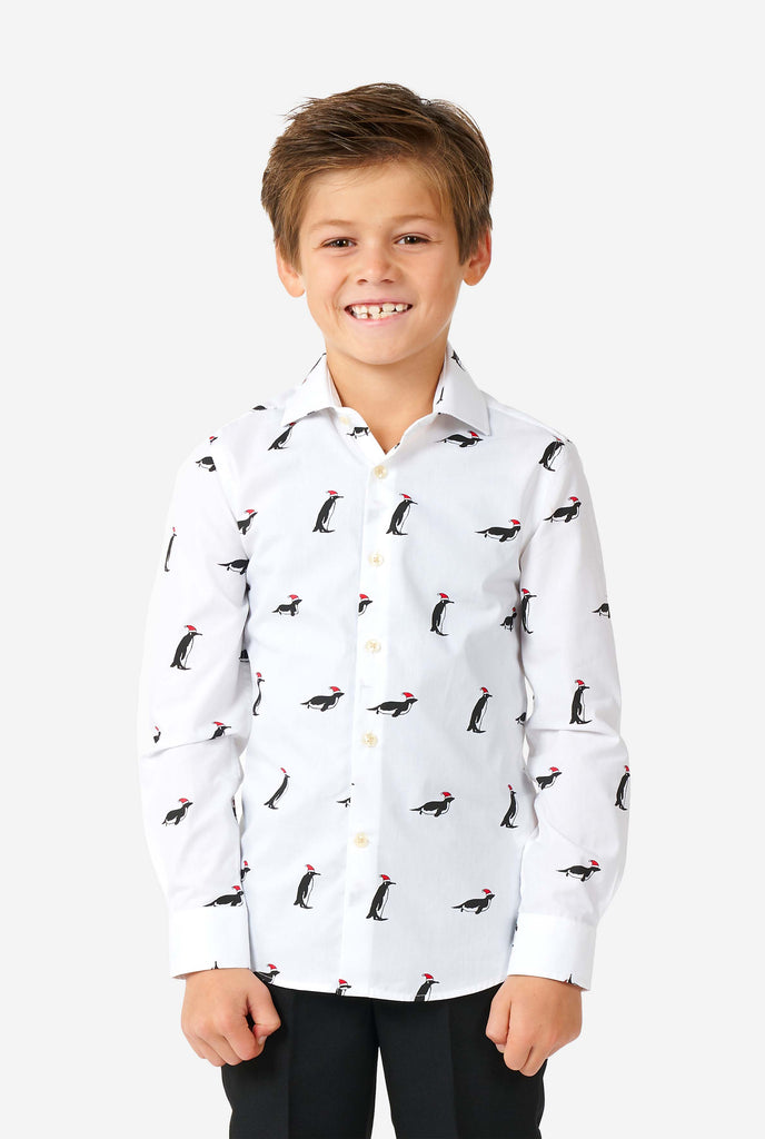 White Christmas dress shirt with Christmas penguins worn by a boy zoomed in