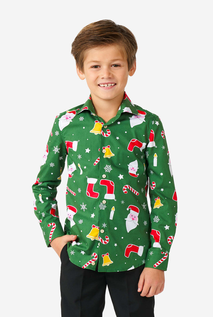 Kid wearing green Christmas shirt with Christmas icons