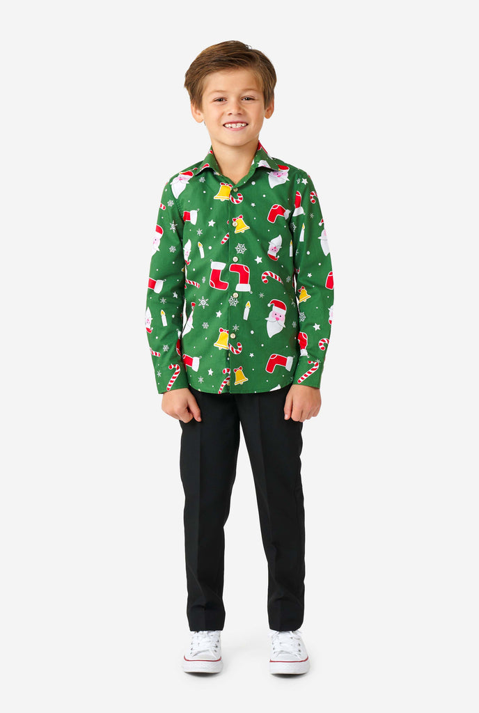 Kid wearing green Christmas shirt with Christmas icons