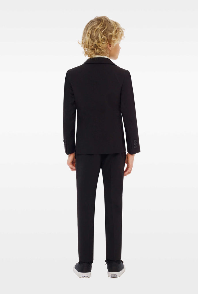 Black suit for boys worn by boy from the back