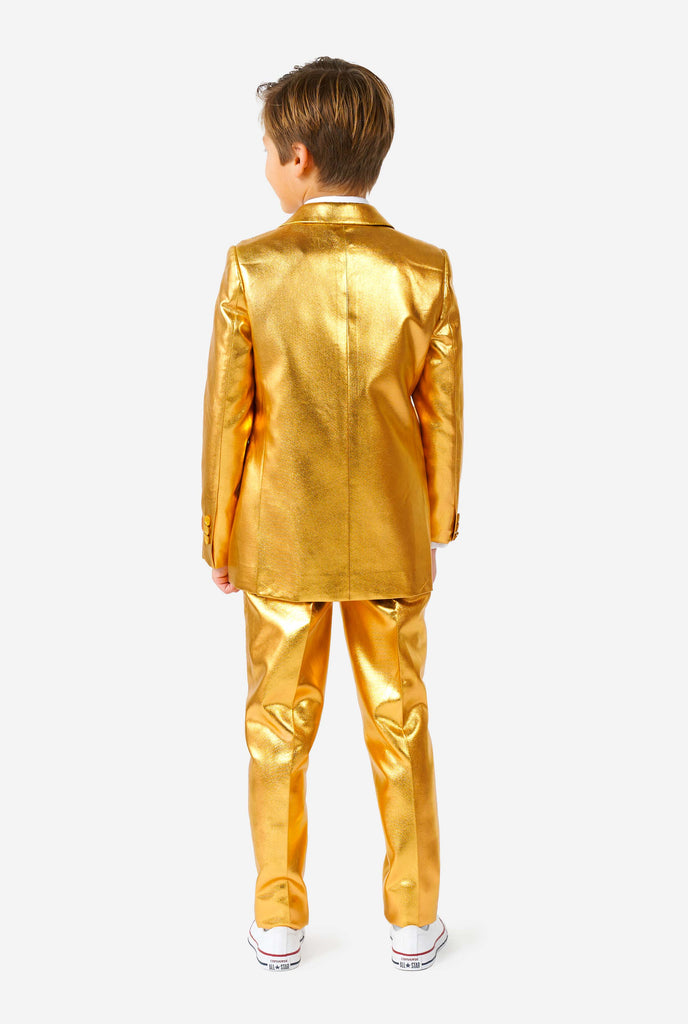 Boy wearing shining groovy gold suit, view from the back