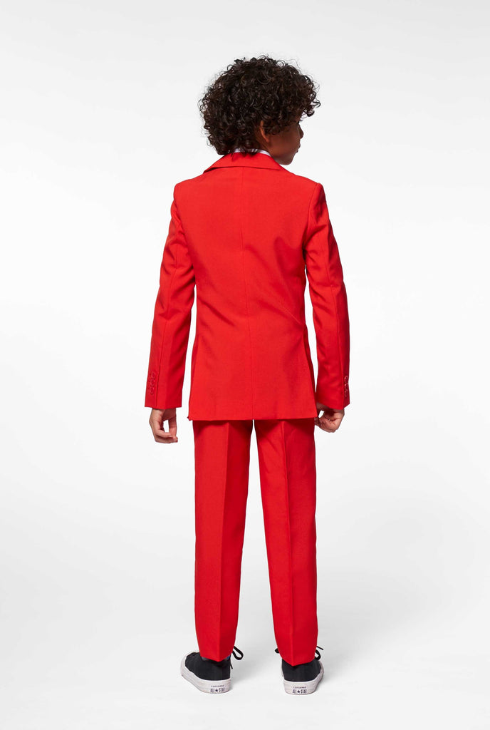 Red suit for boys worn by boy from the back