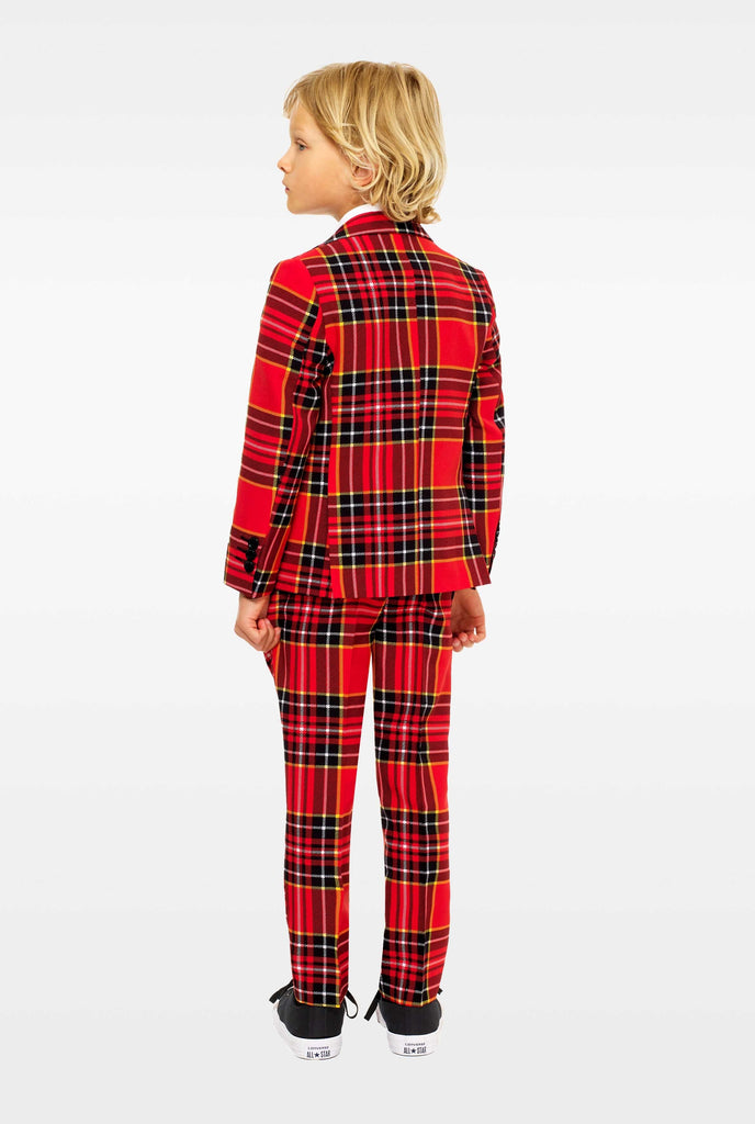 Red plaid suit for boys worn by boy from the back