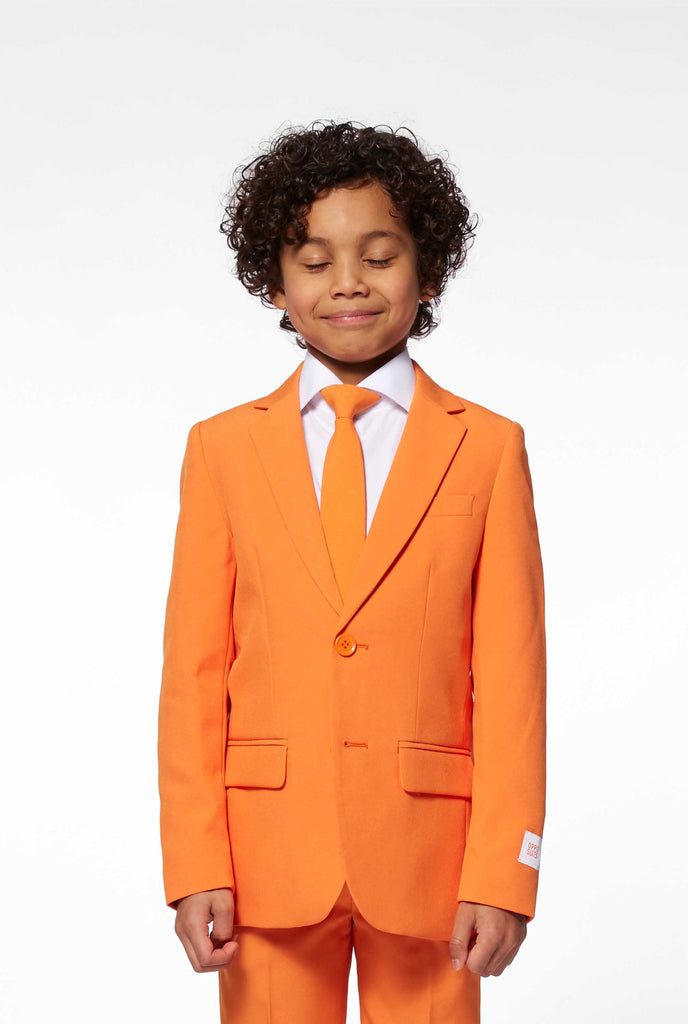 Solid colored orange boys suit worn by boy