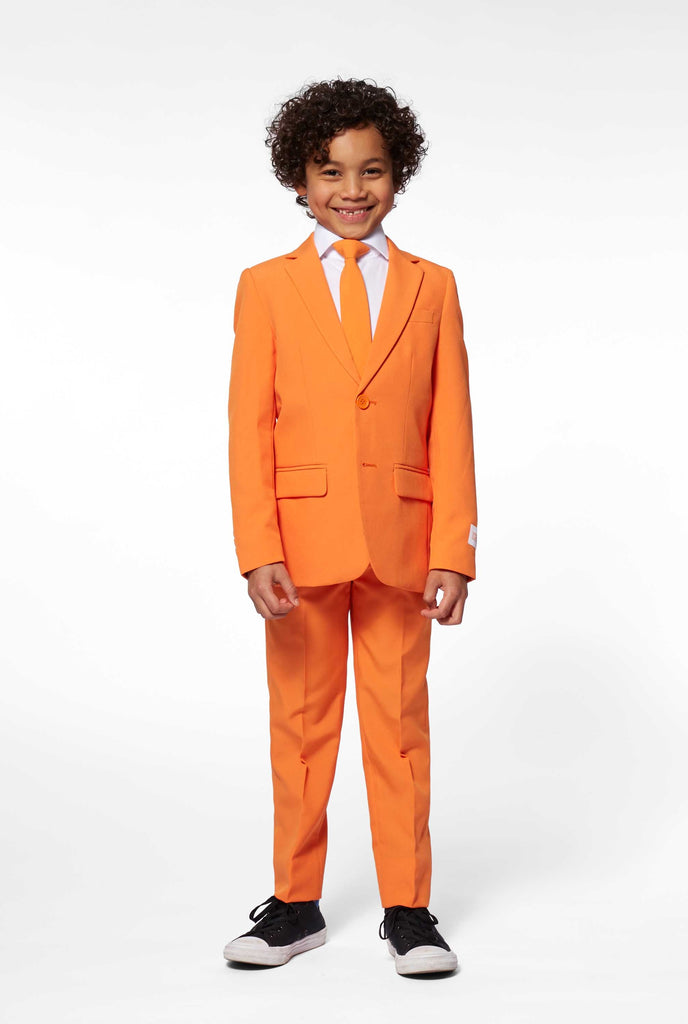 Solid colored orange boys suit worn by boy