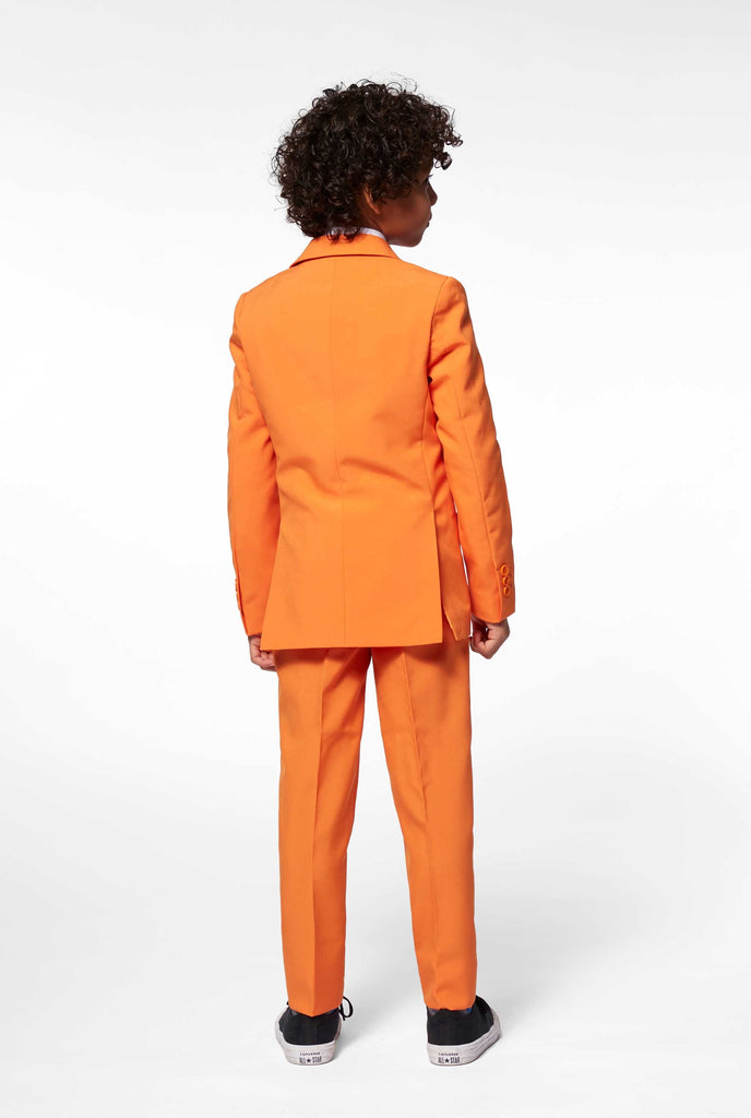 Solid colored orange boys suit worn by boy from the back