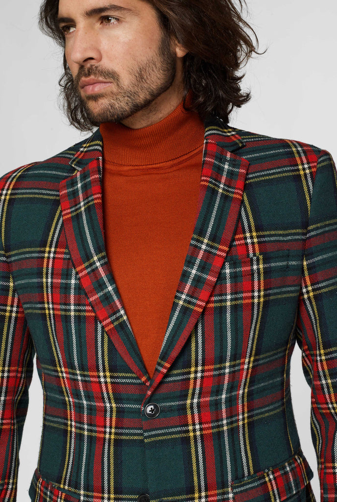 Red and green tartan blazer worn by man, close up