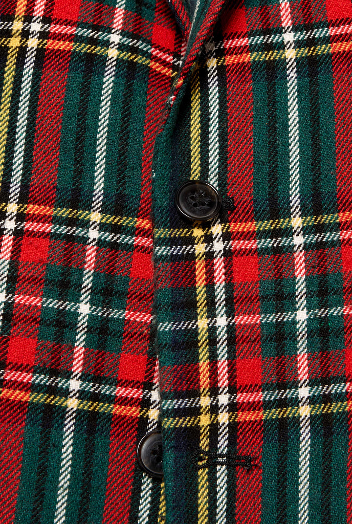 Red and green tartan blazer worn by man, close up