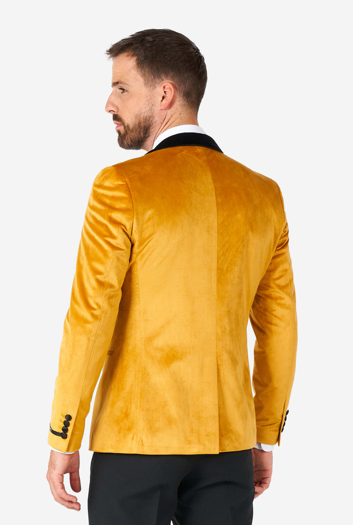 Man wearing golden velvet dinner jacket blazer, view from the back