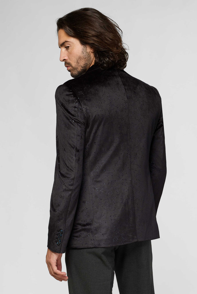 Black jacket with constellation pattern worn by man showing back of jacket