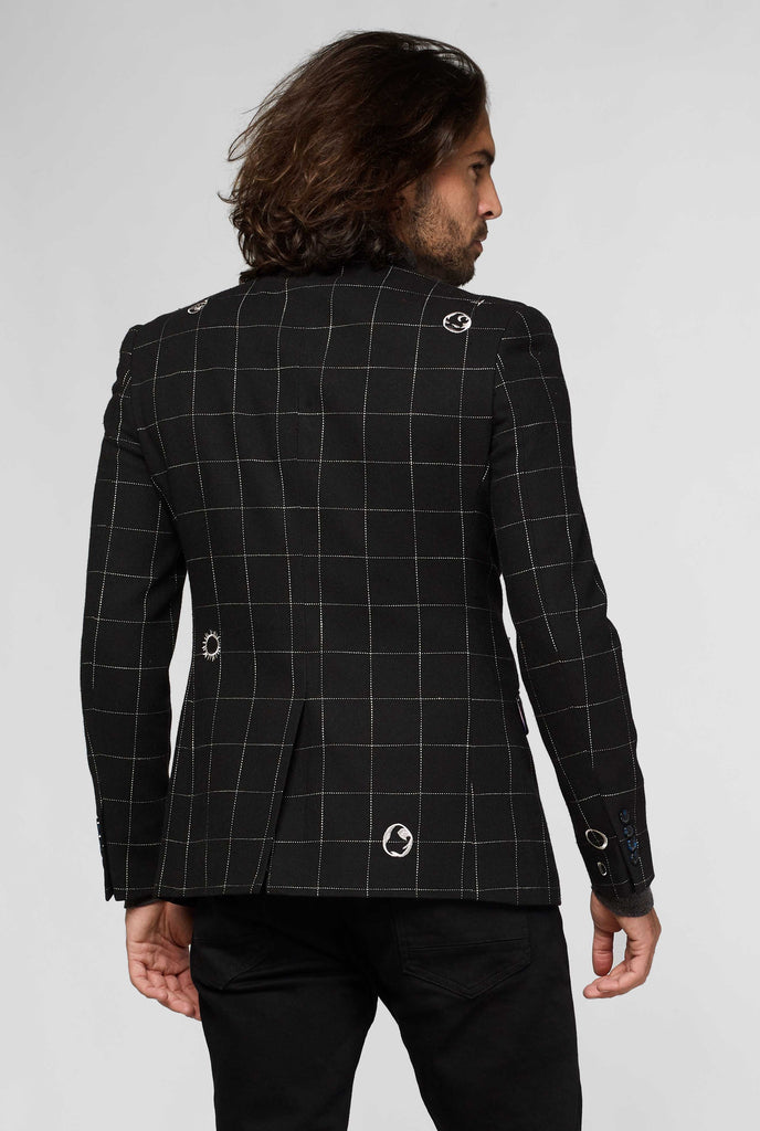 Black jacket with white grid pattern worn by man showing back