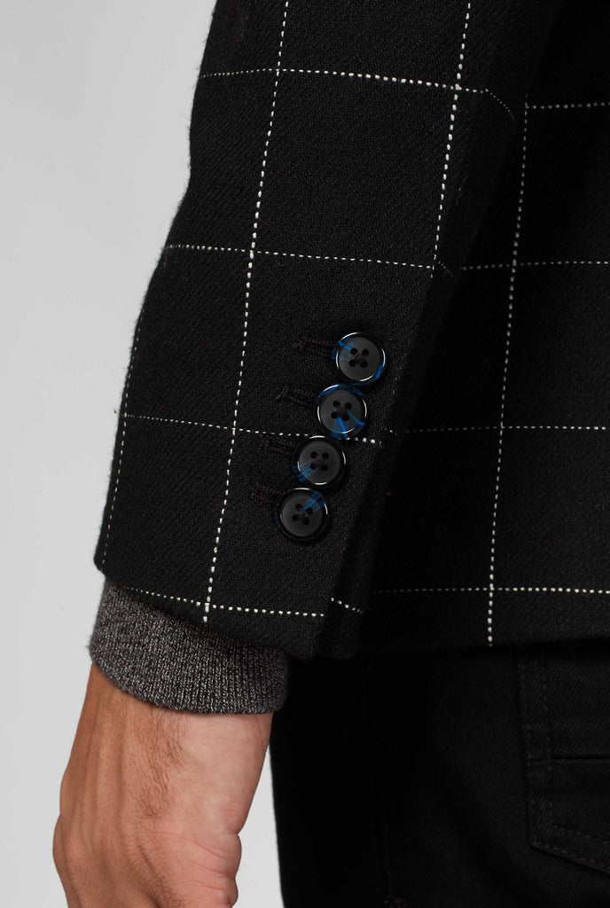 Black jacket with white grid pattern sleeve up close