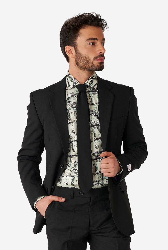 Man wearing shirt with dollar print and black suit