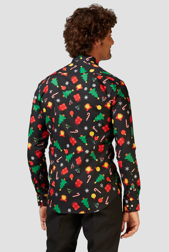 Man wearing black dress shirt with Christmas icons, view from the back