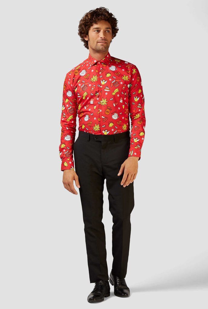 Man wearing red dress shirt with Christmas icons and black pants