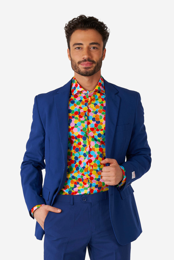 Man wearing multi color dress shirt with confetti print and blue men's suit