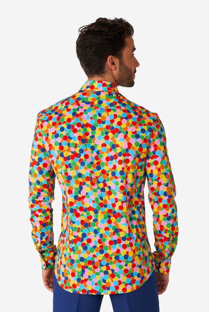 Man wearing multi color dress shirt with confetti print, view from the back