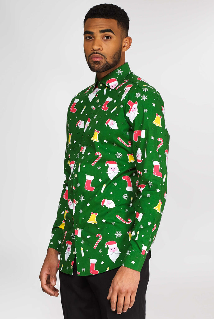 Man wearing green Christmas dress shirt with Christmas icons