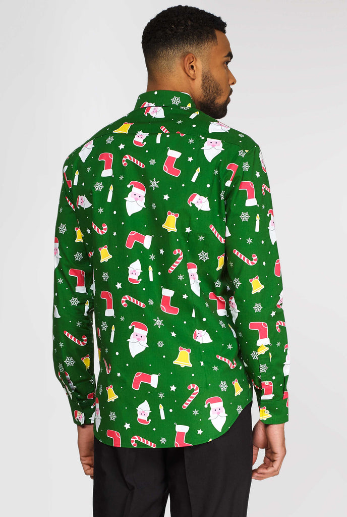 Man wearing green Christmas dress shirt with Christmas icons, view from the back