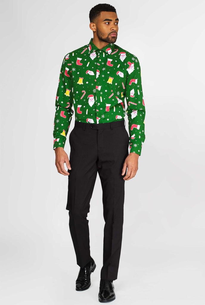 Man wearing green Christmas dress shirt with Christmas icons