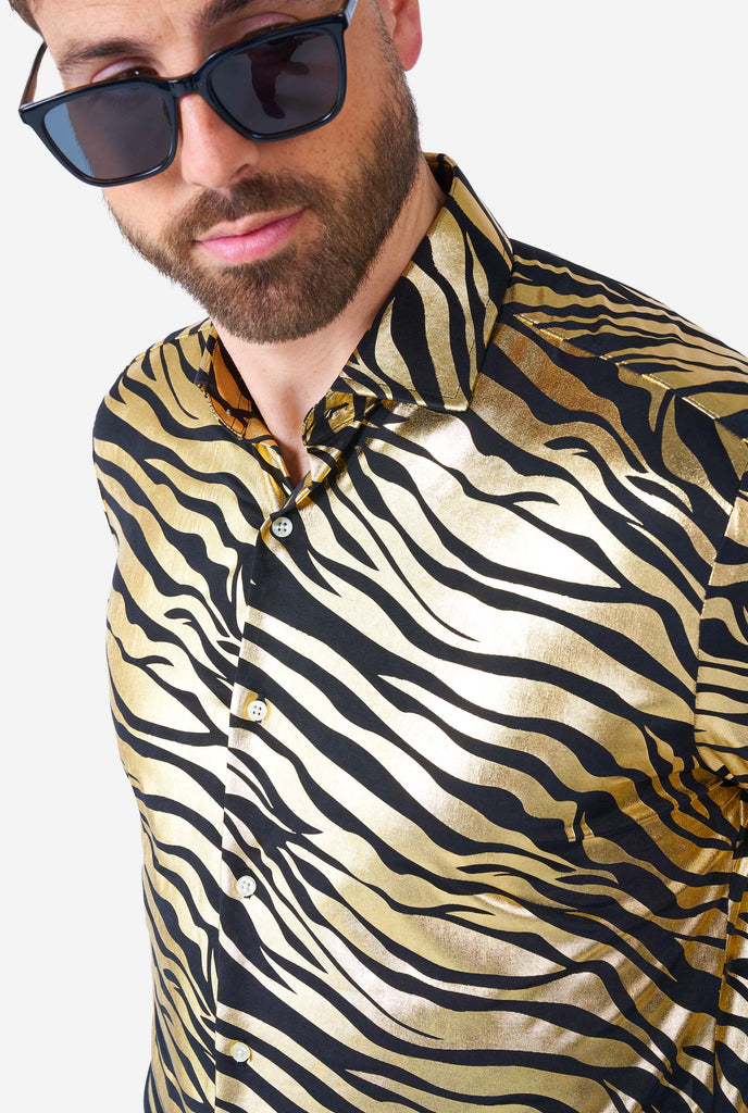 Man wearing golden dress shirt with tiger stripes, close up