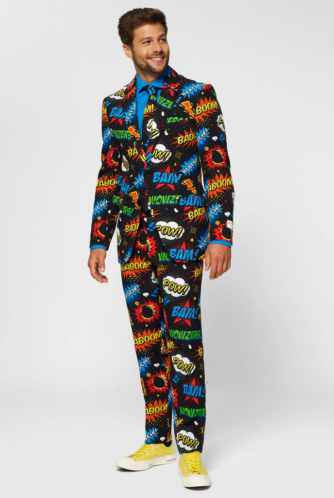 Black suit with comic book icons worn by man looking to the side