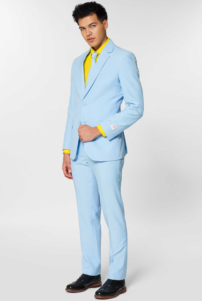 Man wearing light blue men's suit and yellow dress shirt