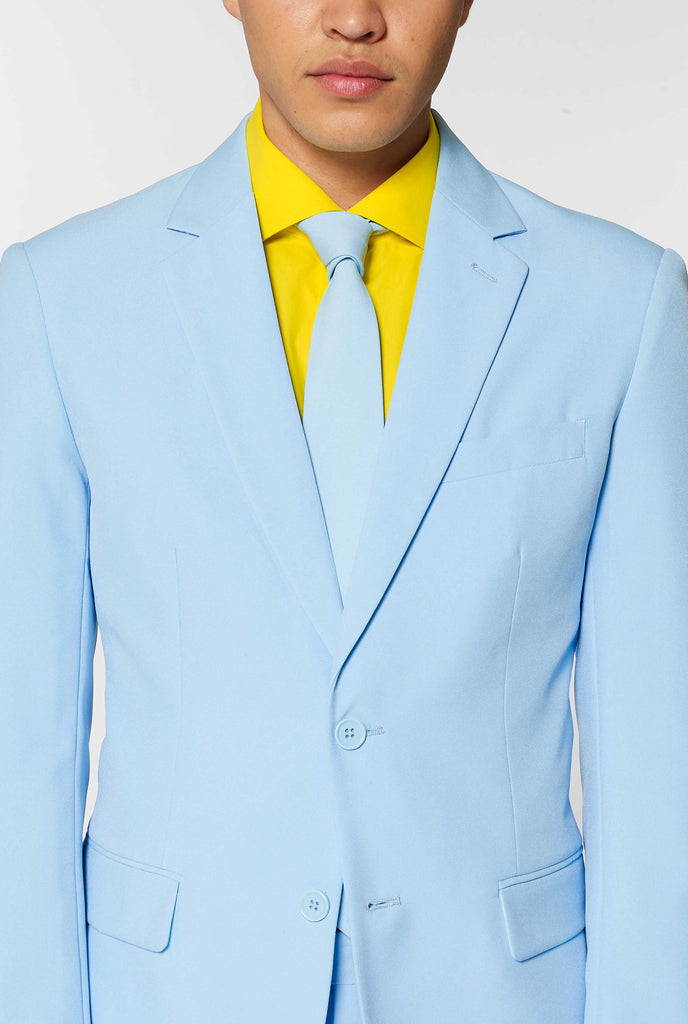 Man wearing light blue men's suit and yellow dress shirt, close up