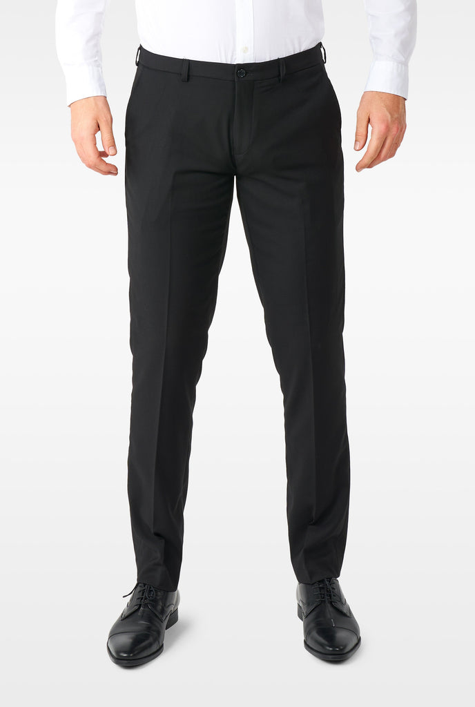 Man wearing casual black business suit, view of pants