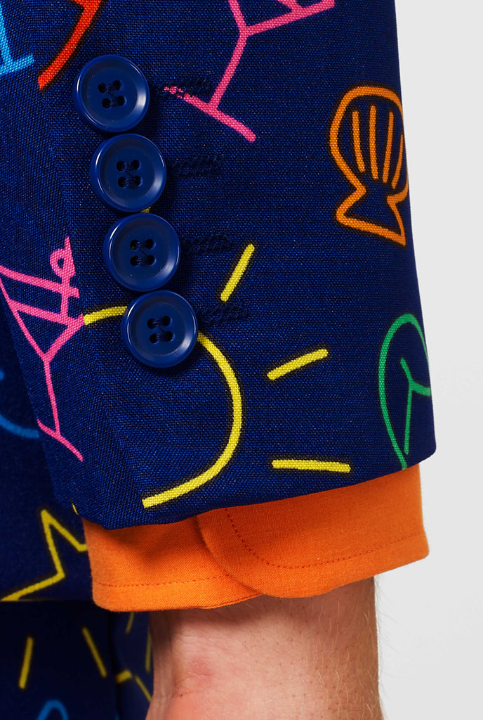 Dark blue suit with bright doodle iconography worn by man