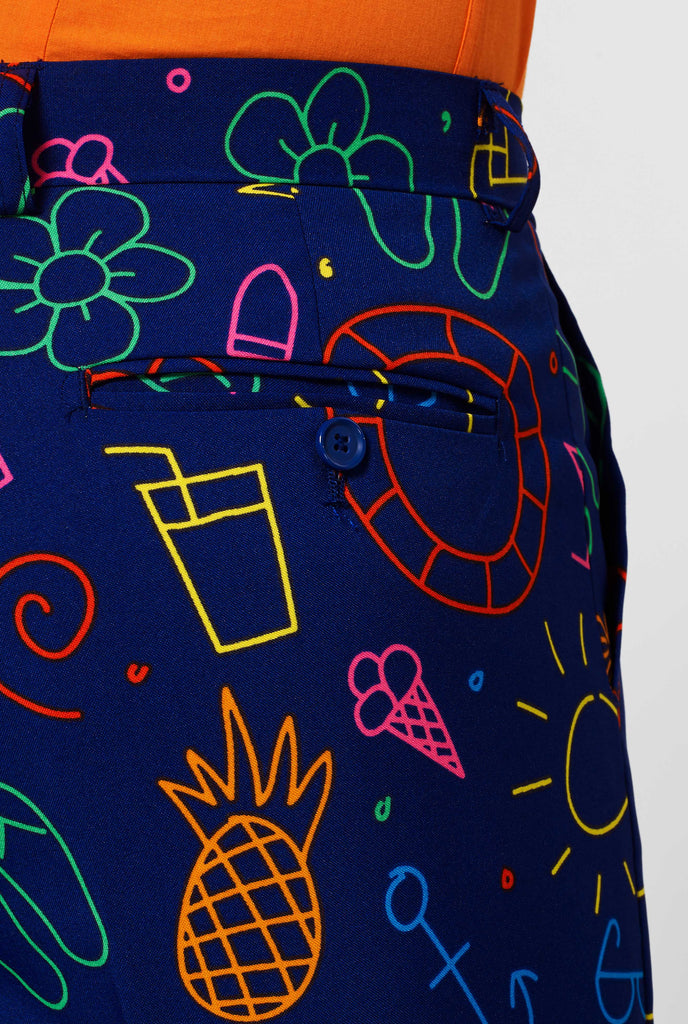 Dark blue suit pants with bright doodle iconography worn by man