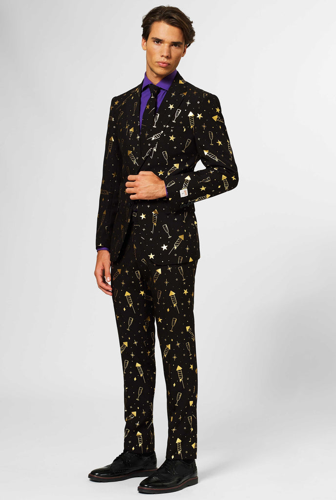 Black men's suit with golden fireworks print worn by man