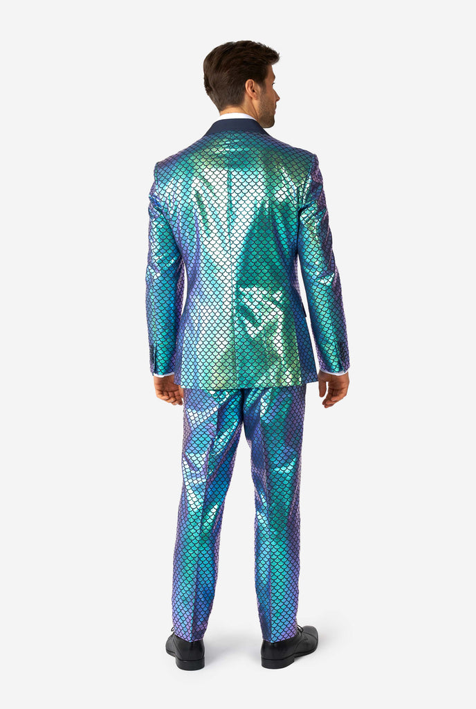 Man wearing blue fish scale motive suit, view from the back