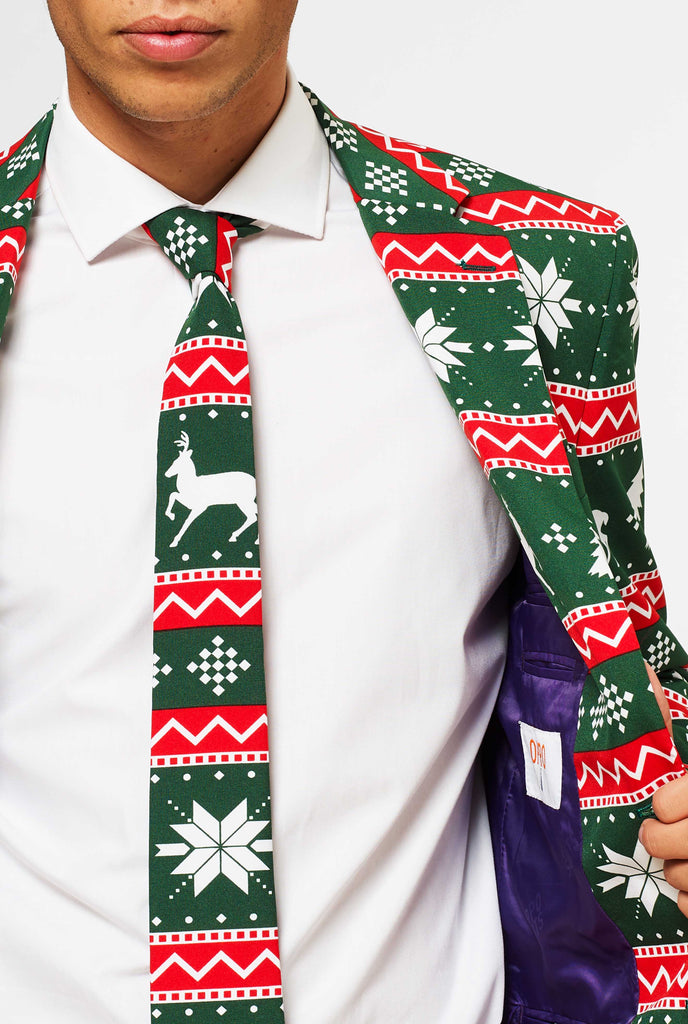 Green and red Christmas themed men's suit worn by man close up view