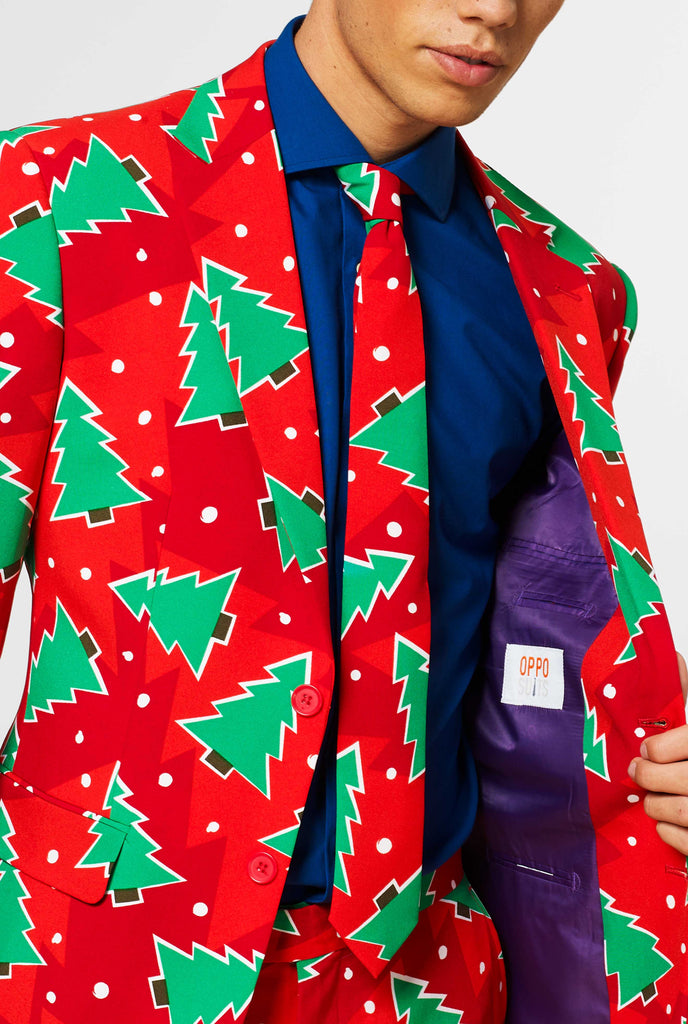 Red Christmas suit with pine tree print worn by man showing inside of jacket