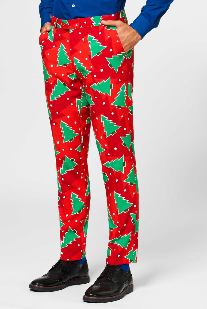 Red Christmas pants with pine tree print worn by man