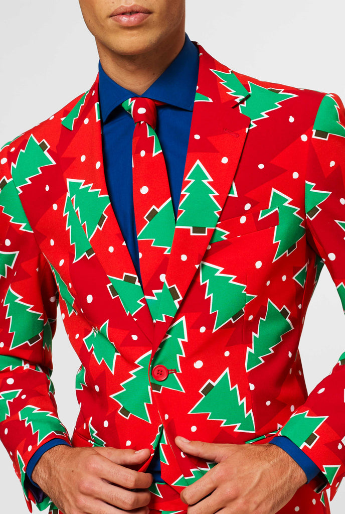 Red Christmas suit with pine tree print worn by man