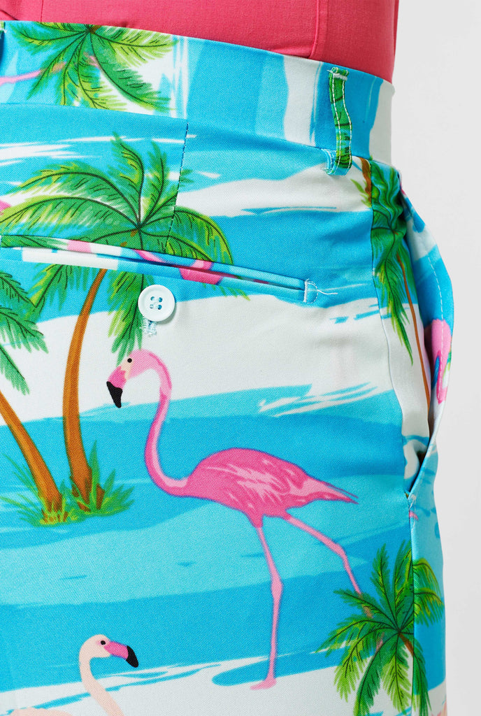 Blue and white pants with tropical flamingo print up close