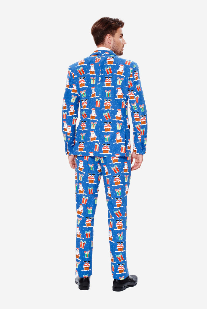 Man wearing blue Christmas suit with Christmas icons, view from the back