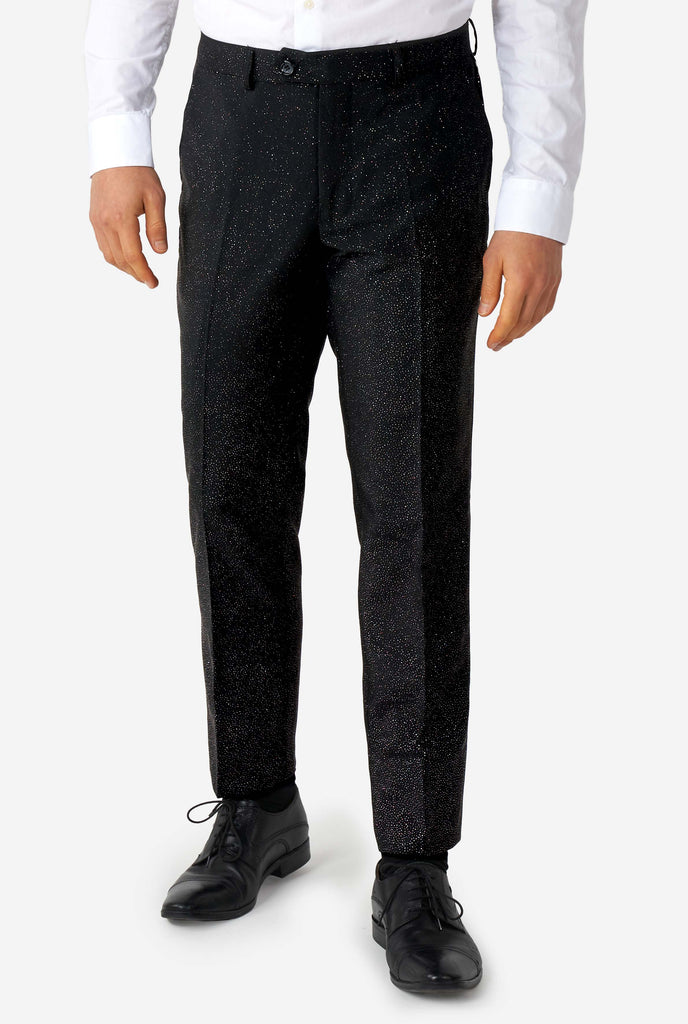 Man wearing black suit with glitter pants view