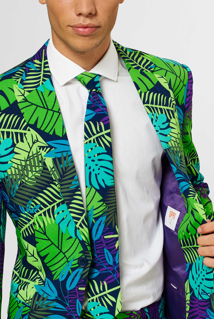 Jungle suit with green and purple leaf print by man shown inside of jacket